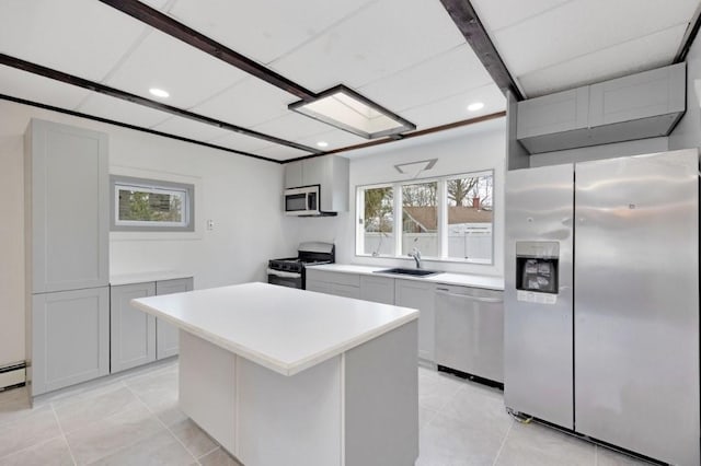 kitchen featuring light countertops, recessed lighting, a sink, and stainless steel appliances