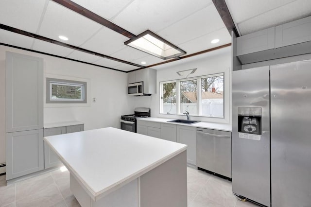 kitchen featuring light tile patterned floors, a sink, light countertops, recessed lighting, and stainless steel appliances