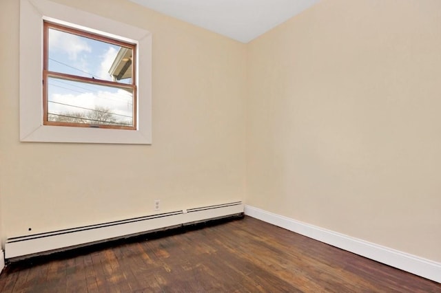 unfurnished room with baseboards, dark wood-style floors, and baseboard heating