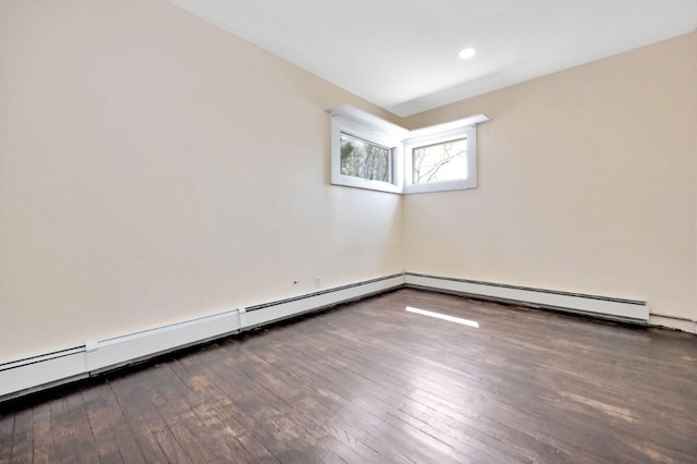 empty room with baseboard heating, baseboards, and hardwood / wood-style floors