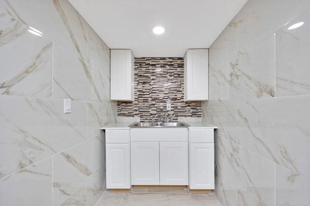 bathroom featuring recessed lighting, marble finish floor, and a sink