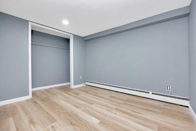 unfurnished bedroom featuring baseboards, recessed lighting, wood finished floors, and baseboard heating