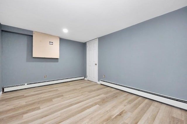 finished below grade area with baseboards, recessed lighting, light wood-style floors, and baseboard heating
