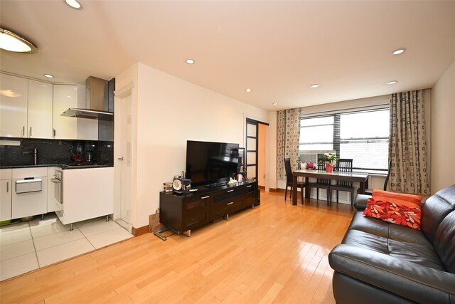 99-60 63rd Rd Unit 9Y, Rego Park, NY 11374 - living area with recessed lighting, light wood-style floors, and baseboards