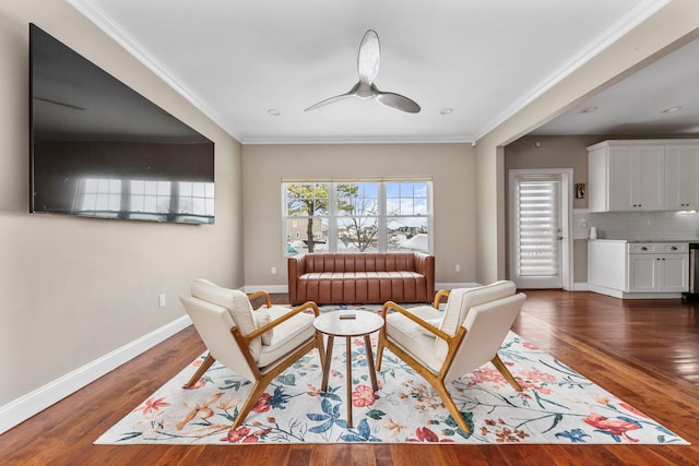living room featuring crown molding, wood finished floors, and a ceiling fan