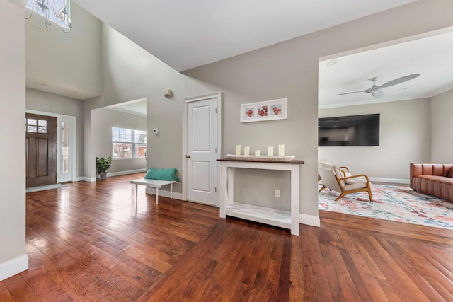 entryway featuring a high ceiling, baseboards, a ceiling fan, and hardwood / wood-style flooring