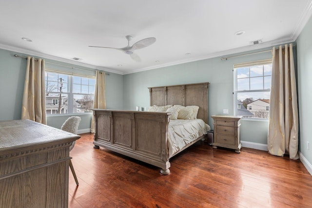 bedroom with visible vents, ceiling fan, crown molding, and dark wood-style floors
