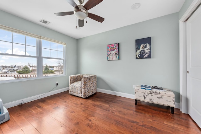 sitting room with visible vents, baseboards, a ceiling fan, and wood finished floors