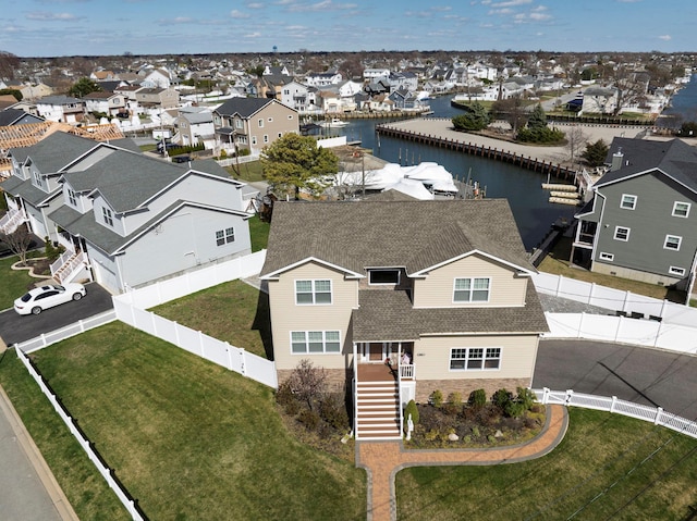 bird's eye view with a water view and a residential view