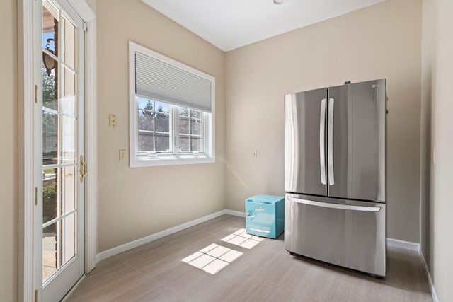 kitchen with baseboards and freestanding refrigerator