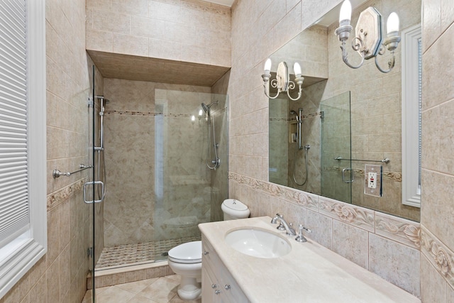 bathroom with tile patterned flooring, toilet, a shower stall, and vanity