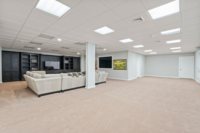 living room with visible vents, baseboards, a paneled ceiling, and light carpet