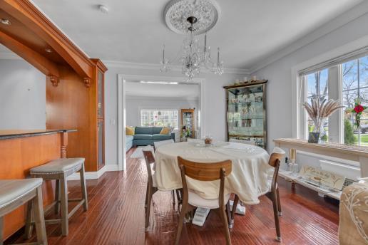 dining area with an inviting chandelier, ornamental molding, and a healthy amount of sunlight