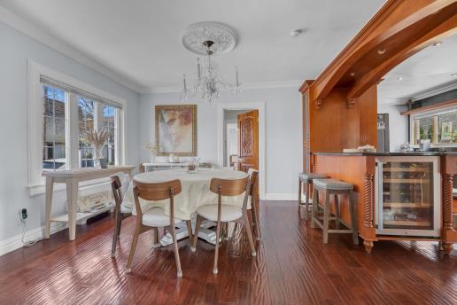 dining space with wine cooler, baseboards, a healthy amount of sunlight, and crown molding