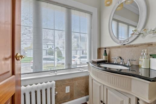 bathroom featuring radiator and vanity