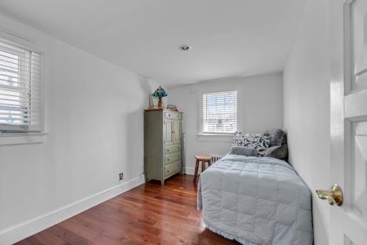 living area with baseboards and wood finished floors