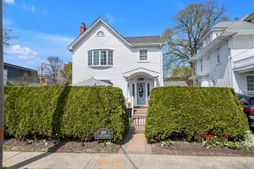 view of front of home with a gate, fence private yard, and a chimney