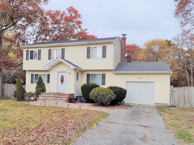7 Murray Ln, Coram, NY 11727 - colonial inspired home featuring an attached garage, asphalt driveway, and a chimney