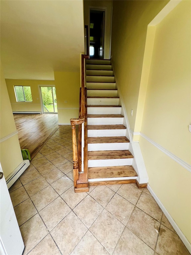 7 Murray Ln, Coram, NY 11727 - stairs with baseboard heating, tile patterned flooring, and a baseboard radiator
