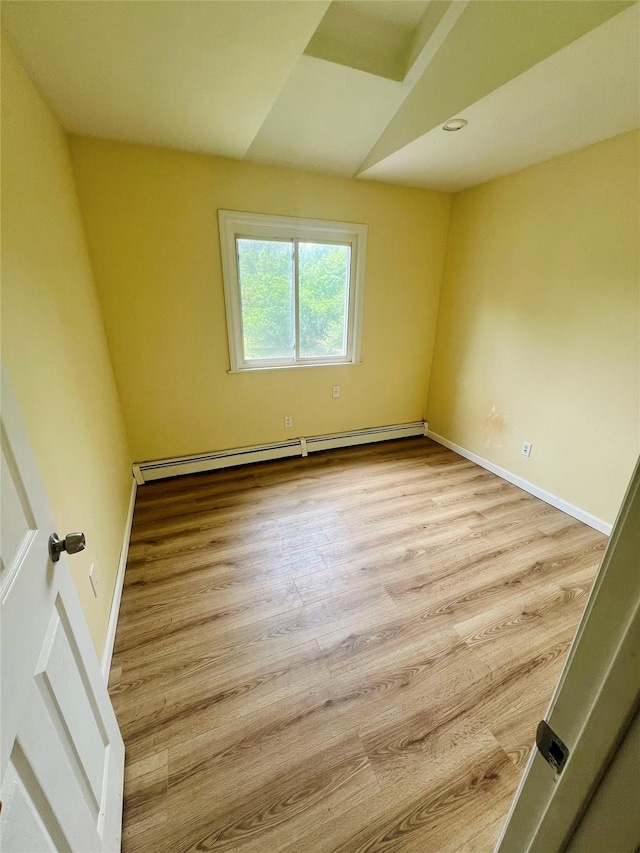7 Murray Ln, Coram, NY 11727 - spare room featuring a baseboard radiator and wood finished floors