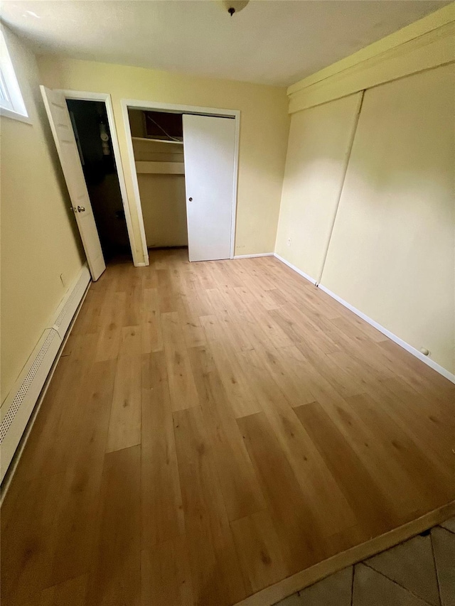 7 Murray Ln, Coram, NY 11727 - unfurnished bedroom with light wood-style flooring and multiple closets