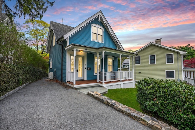 bungalow featuring roof with shingles and covered porch