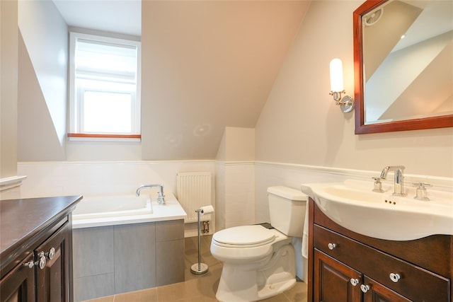 full bathroom with vanity, toilet, tile patterned floors, a wainscoted wall, and a garden tub