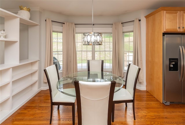 dining area featuring light wood-style flooring and a chandelier