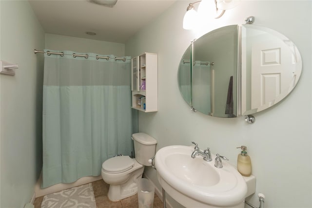 full bath with a sink, toilet, tile patterned flooring, and shower / bath combination with curtain