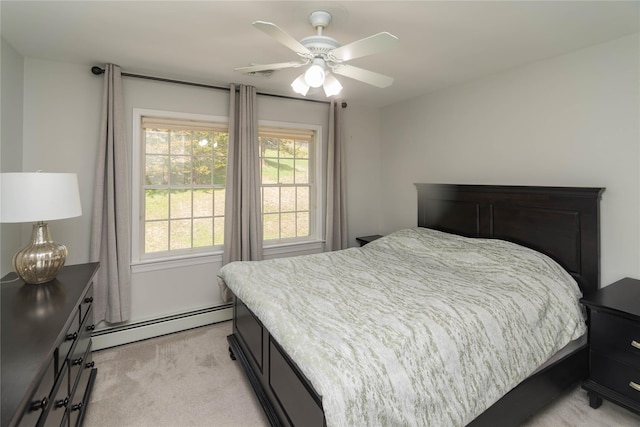 bedroom with light colored carpet, multiple windows, ceiling fan, and a baseboard heating unit