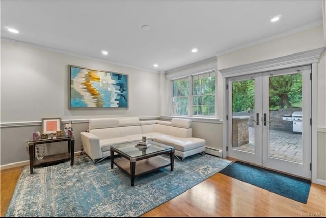 living area featuring french doors, a baseboard heating unit, ornamental molding, and wood finished floors
