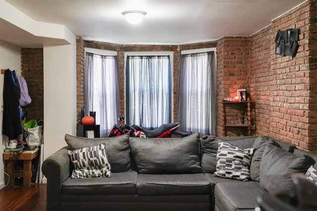 138 S Clark St, Newburgh, NY 12550 - living room featuring brick wall, wood finished floors, and plenty of natural light