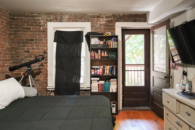 138 S Clark St, Newburgh, NY 12550 - bedroom with light wood finished floors and brick wall