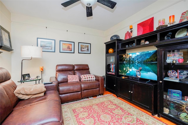 living area featuring wood finished floors and ceiling fan