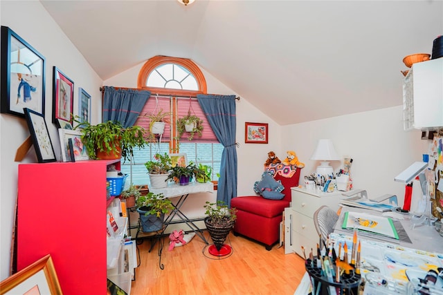 interior space with wood finished floors and vaulted ceiling