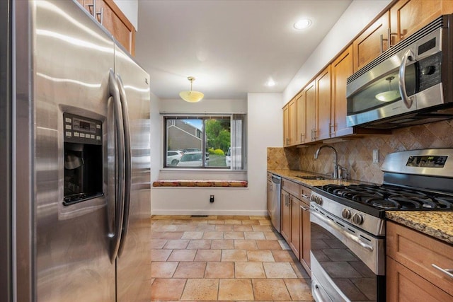 19 James Ct Unit 19, Port Chester, NY 10573 - kitchen with appliances with stainless steel finishes, a sink, baseboards, tasteful backsplash, and light stone countertops