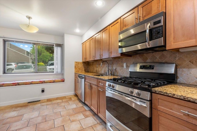 19 James Ct Unit 19, Port Chester, NY 10573 - kitchen featuring appliances with stainless steel finishes, a sink, baseboards, light stone counters, and tasteful backsplash