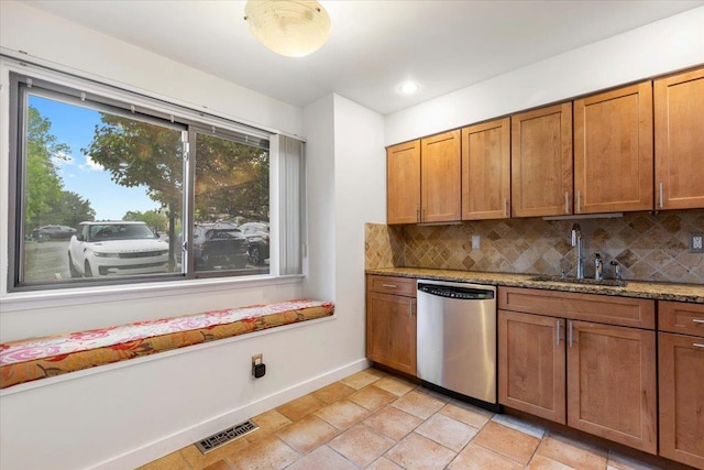 19 James Ct Unit 19, Port Chester, NY 10573 - kitchen featuring stainless steel dishwasher, a sink, baseboards, tasteful backsplash, and brown cabinetry