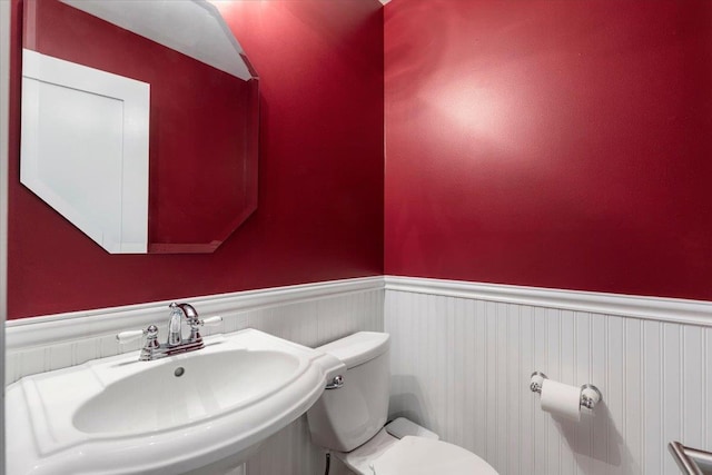 19 James Ct Unit 19, Port Chester, NY 10573 - bathroom featuring a wainscoted wall, a sink, and toilet
