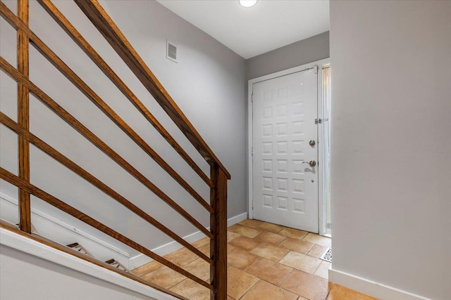 19 James Ct Unit 19, Port Chester, NY 10573 - foyer with baseboards, light stone finish flooring, and stairs
