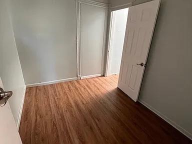 unfurnished bedroom featuring baseboards and wood finished floors