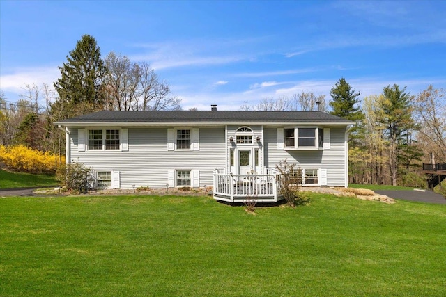 view of front of property with a deck and a front yard