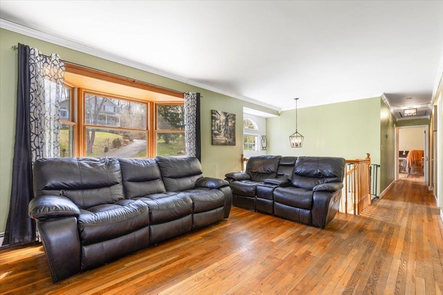 living room with hardwood / wood-style flooring and crown molding