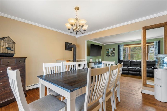 dining space featuring a baseboard radiator, wood finished floors, crown molding, and a notable chandelier
