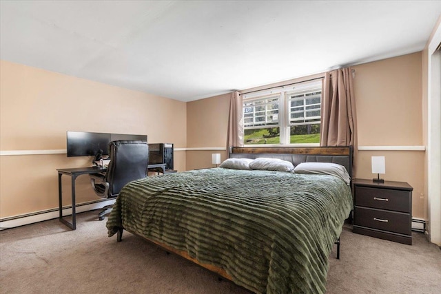 bedroom featuring a baseboard heating unit, light colored carpet, and baseboard heating
