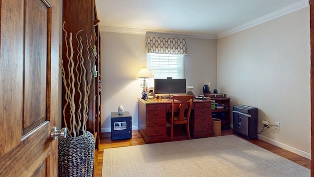 office area with crown molding, wood finished floors, and baseboards