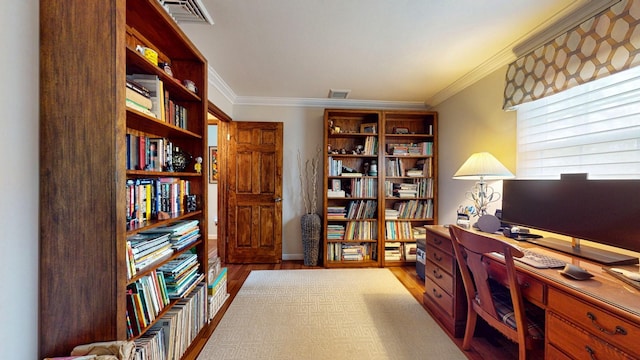 office area with visible vents, crown molding, and wood finished floors