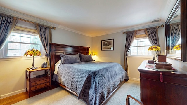bedroom featuring visible vents, baseboards, and ornamental molding