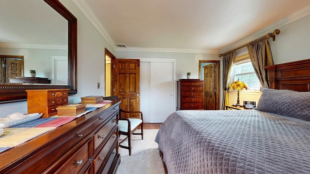 bedroom with visible vents, ornamental molding, and wood finished floors