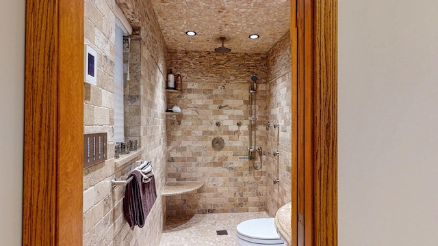 full bath featuring toilet and a tile shower